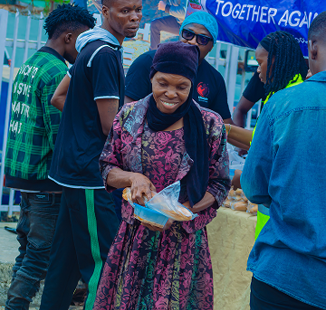 Scientist in white lab coat and blue gloves carefully using a pipette to transfer liquid into a test tube beside a microscope in a modern clinical laboratory